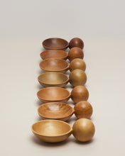Load image into Gallery viewer, An image of all versions of the Moon Spoon, a hand carved spoon made from native timbers, the spoon bowl is deep and the handle is a hand carved sphere. All spoons in each timber are sitting on a white background set out in a descending line, the spoon Saer sitting side on the bowls facing left, the spheres facing right.