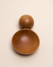 Load image into Gallery viewer, A hand carved spoon made of swamp kauri on a white back ground, the spoon bowl is deep and round and the handle is a hand carved sphere.