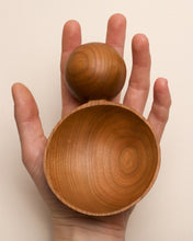 Load image into Gallery viewer, A hand holding a hand carved spoon made of rosewood on a white back ground, the spoon bowl is deep and round and the handle is a hand carved sphere.