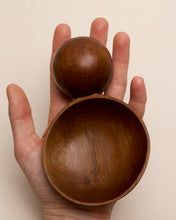 Load image into Gallery viewer, A hand holding a hand carved spoon made of miro on a white back ground, the spoon bowl is deep and round and the handle is a hand carved sphere.