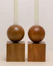 Load image into Gallery viewer, Two Hand-carved candle holder made from kauri and Tōtara wood, featuring a spherical base atop a square block.