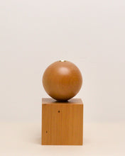Load image into Gallery viewer, Hand-carved candle holder made from kauri wood, featuring a spherical base atop a square block.