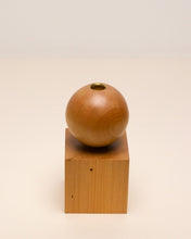 Load image into Gallery viewer, Hand-carved candle holder made from kauri wood, featuring a spherical base atop a square block.