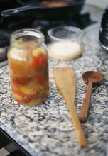 Load image into Gallery viewer, a hand carved wooden spatula and a hand carved wooden spoon both made using native New Zealand timber by Courtney Petley  sitting on a kitchen bench next to a jar of pickled tomatoes.