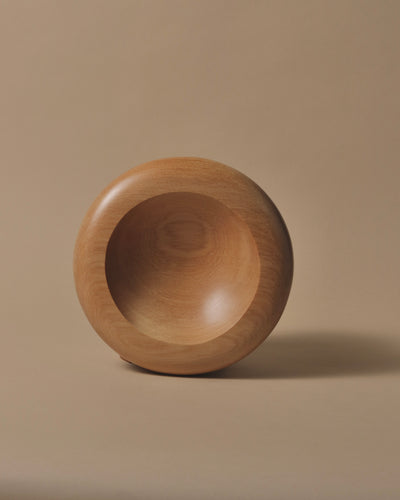 A round Kauri bowl with a soft rounded edge, wide lip, and smooth shallow bowl.