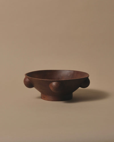 A round Bowl made from one piece of Swamp Kauri, 5 hand spheres around the edge and sitting on a raised base.