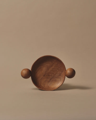 Small round hand carve Swamp Kauri dish with two hand carved spheres that sit either side of the bowl.