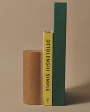 Load image into Gallery viewer, Handcrafted oak bookend holding two books, including &#39;Ottolenghi Simple,&#39; showcasing a minimalist and elegant design.