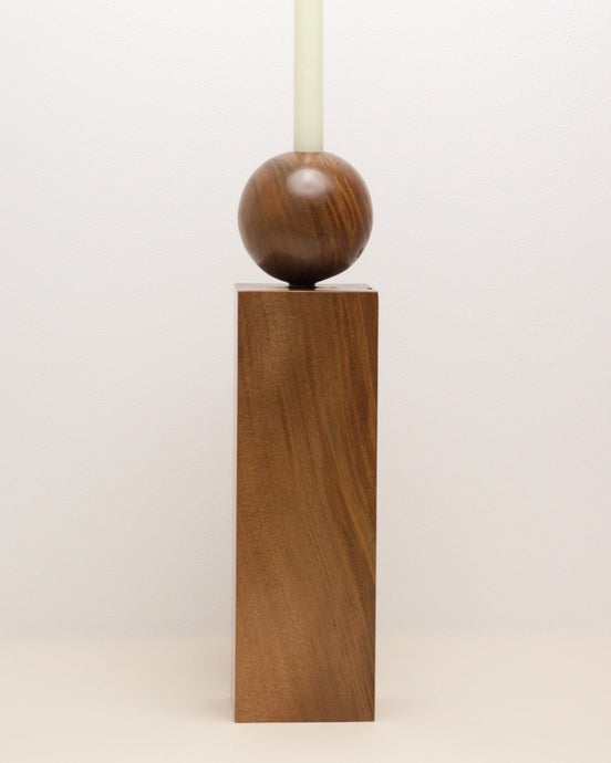 Hand-carved swamp kauri candleholder, featuring a spherical base atop a square block, part of the Moon Series collection.
