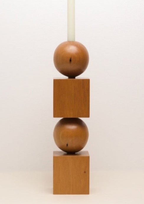 Hand-carved kauri candleholder from the Moon Series, featuring a spherical base atop a square block.